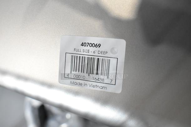 Label on stainless steel steam table pan reads "Full Size - 6'' Deep, Made in Vietnam" with barcode and item number 4070069.