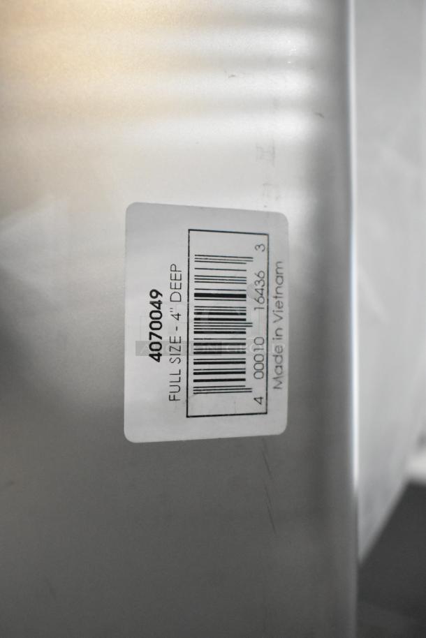 Label on stainless steel hotel pan, reads "Full Size - 4" Deep, Made in Vietnam" with barcode and item number 4070049.