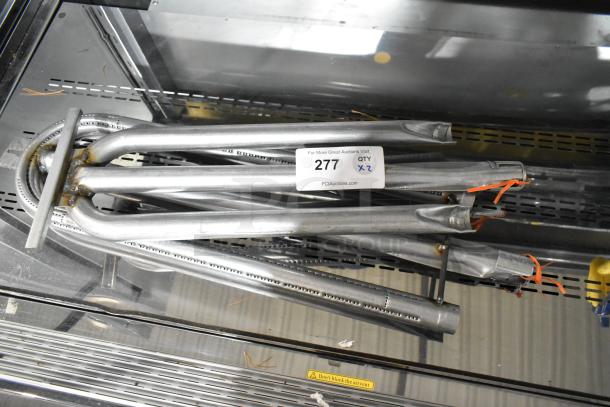 Two brand new metal burners, scratched and dented, with auction tag reading '277 QTY x2'.