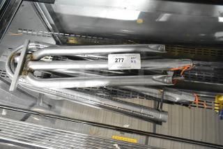 Two brand new metal burners, scratched and dented, with auction tag reading '277 QTY x2'.