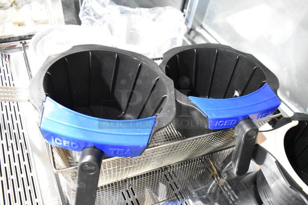 Seven brand new scratch and dent baskets with handles, including Avantco 177PCMAD15 and American Range A33001, shown in a metal rack.
