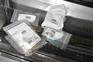 Four brand new scratch and dent items including Frymaster kit, Imperial Range bracket, Moffat fan, and Hatco thermostat. Packaged with visible labels indicating item details.