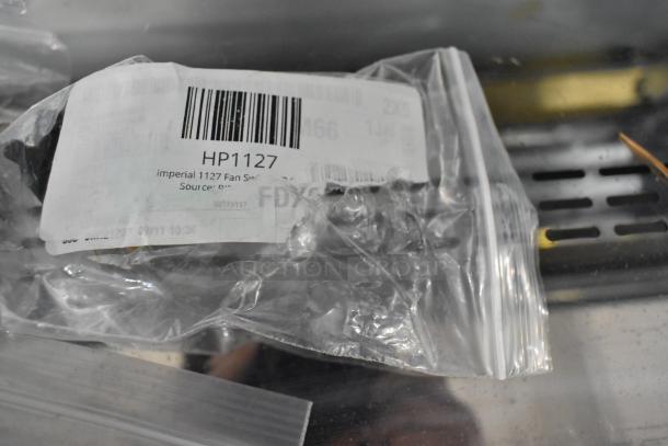 Plastic bag with a label reading "HP1127 Imperial Fan Switch," showing a barcode and text details, reflecting new condition.
