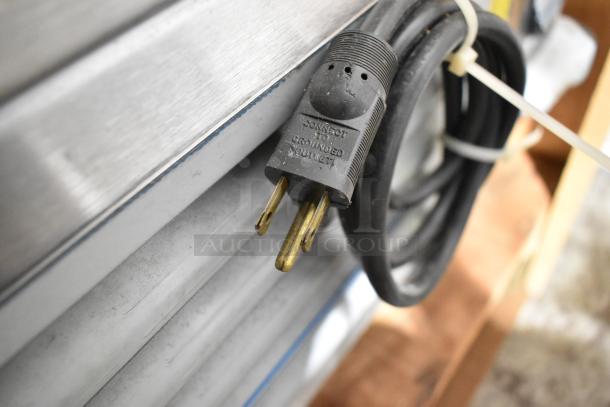 Stainless steel power cord of H&K 52473-1 French fry freezer. Plug reads "Connect is grounded outlet."