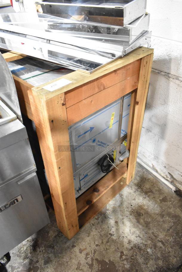 Brand new H&K 52473-1 stainless steel commercial french fry freezer in crate, with fry basket holder and casters. 115V, 1 Phase.