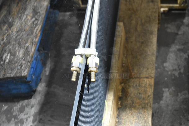 Close-up of the cooling system connections on an Avantco 193HAC51B horizontal air curtain merchandiser.