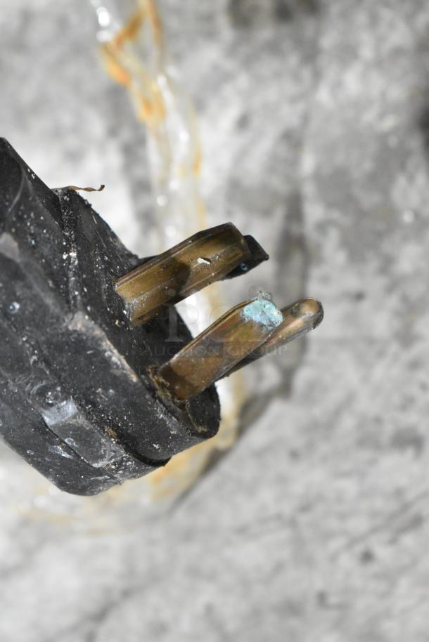 Image showing a close-up of an electrical plug with some corrosion on the prongs, intended for a Bakers Pride 456GDCOER21 oven.