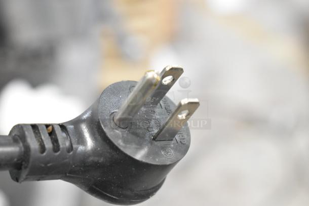 Close-up of a black electrical plug for the True TSCI-600R-G-PH cooler, showcasing the prongs and plug details.