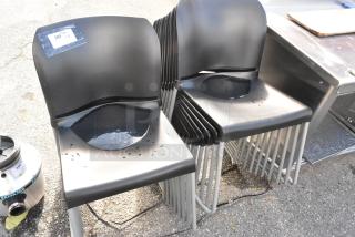 18 black poly stackable chairs on chrome frames, slight wear visible, auction tag marked "300".