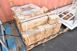Boxes of Lancaster Table & Seating cast iron table base plates on pallet; items include 5"x22" base plates and 10" table spiders.