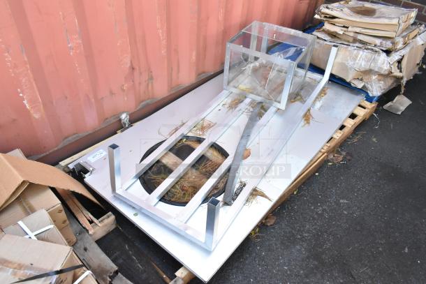 Four new scratch and dent items including a metal swinging kitchen door and metal dunnage rack on a pallet.