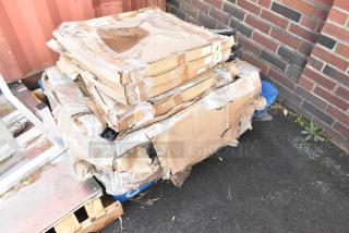 Pallet with 5 Lancaster Table & Seating Metal Table Base Feet in damaged boxes, labeled "FR Feel."