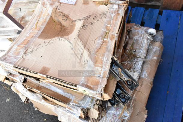 Stack of 5 new scratch and dent Lancaster Table & Seating metal table base feet in opened cardboard packaging.