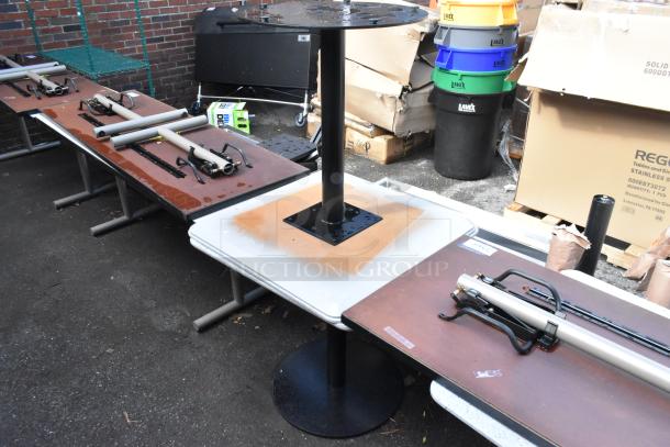 Two white tables with black metal bases, disassembled. Used condition, suitable for restaurant or cafe settings.