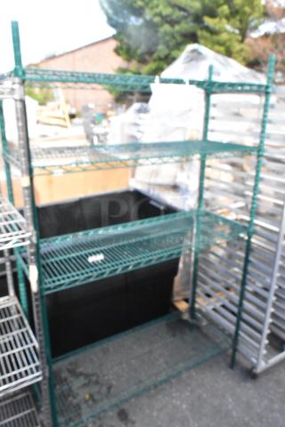 Green 4-tier wire shelving unit, good condition. Buyer must dismantle. Consider freight charges.