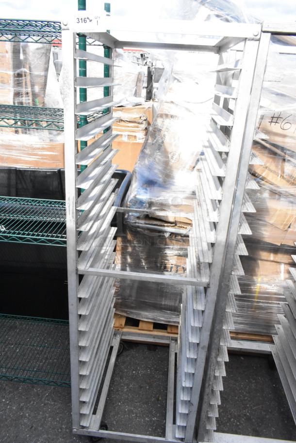 Metal commercial pan transport rack with multiple slots and commercial casters, in good condition.