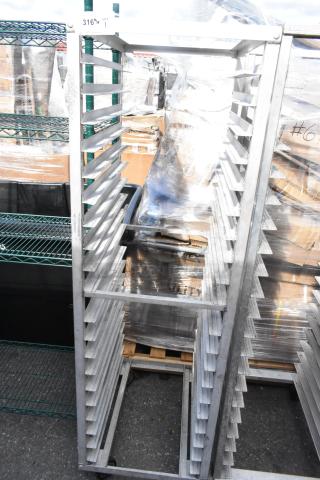 Metal commercial pan transport rack with multiple slots and commercial casters, in good condition.