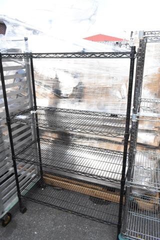 Black finish 4-tier wire shelving unit, adjustable shelves, sturdy, measuring approximately 6ft tall. Buyer must dismantle.