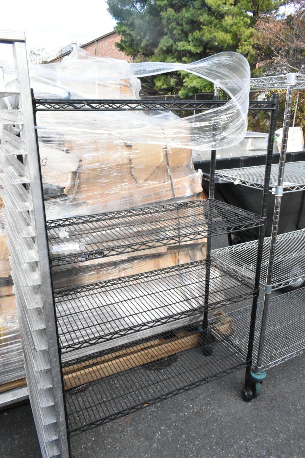 Black finish 4-tier wire shelving unit, sturdy, used condition. Buyer must dismantle. Consider freight charges.