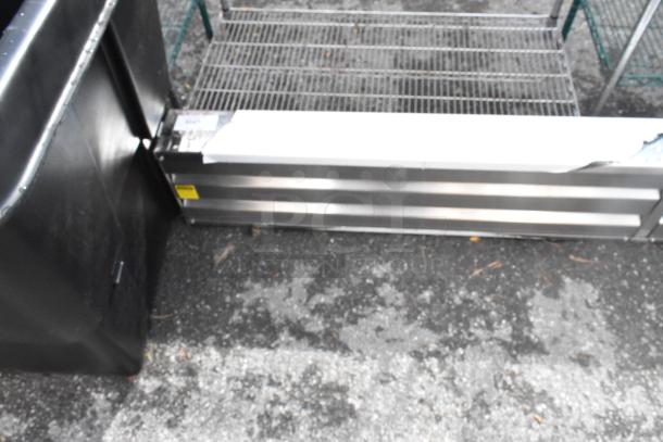 Brand new metal unit with minor scratches and dents. Features steel construction. Auction item on pavement.