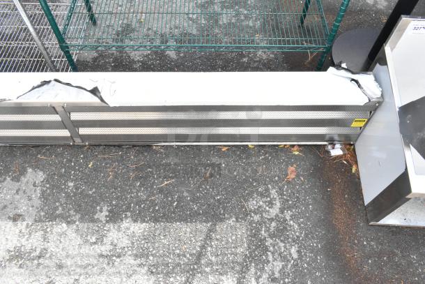 BRAND NEW SCRATCH AND DENT metal unit with visible dents on corners, mesh ventilation front, and yellow safety label.