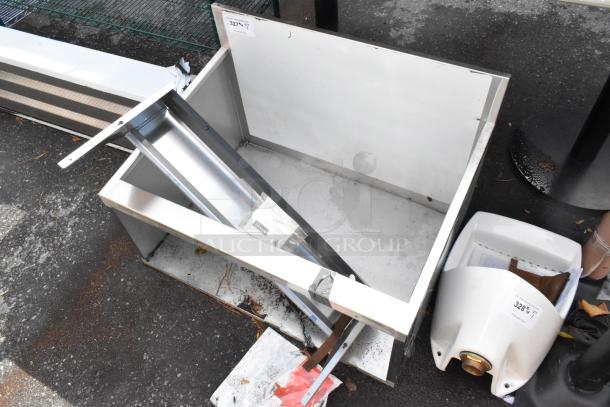 Brand new Perlick stainless steel station, scratch and dent, no legs, visible markings, industrial setting.