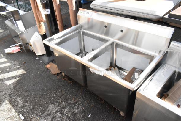 Brand new Regency 600S21818 stainless steel two-compartment sink with 18" x 18" x 14" bowls, galvanized legs, and 2 drainboards.