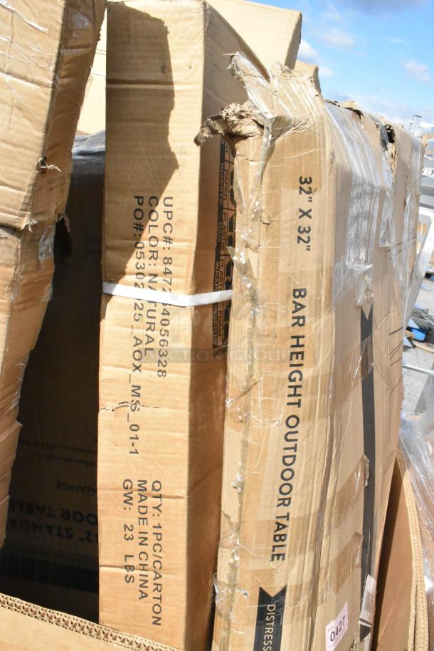 Boxes of a pallet lot labeled with UPC, color, and dimensions. Includes a Regency 18"x60" stainless steel table. Boxes show signs of wear.