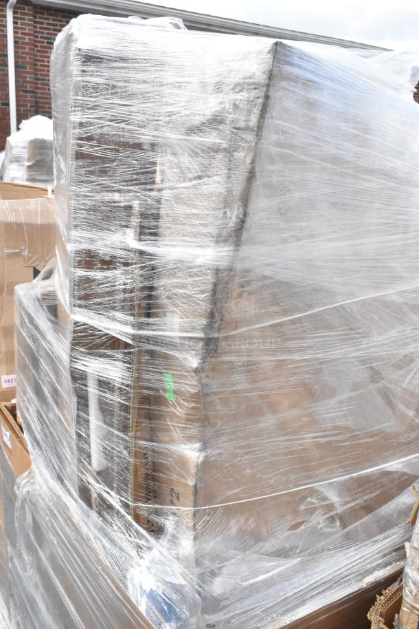 Pallet wrapped in plastic containing new table tops and equipment stand, labeled as scratch and dent items.