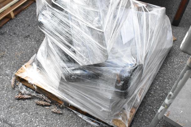 Plastic-wrapped pallet of 13 new Lancaster Table & Seating 10" cast iron table base components, slightly scratched/dented.