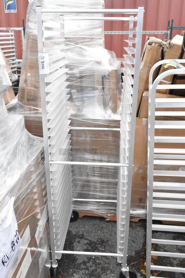 Three metal pan racks, brand new with minor scratches and dents, wrapped and on casters. Auction label visible.