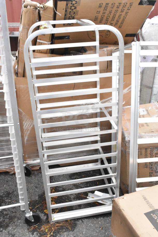 Lot of 3 metal pan racks, brand new, light scratches and dents, silver finish, multiple slots, sturdy construction.