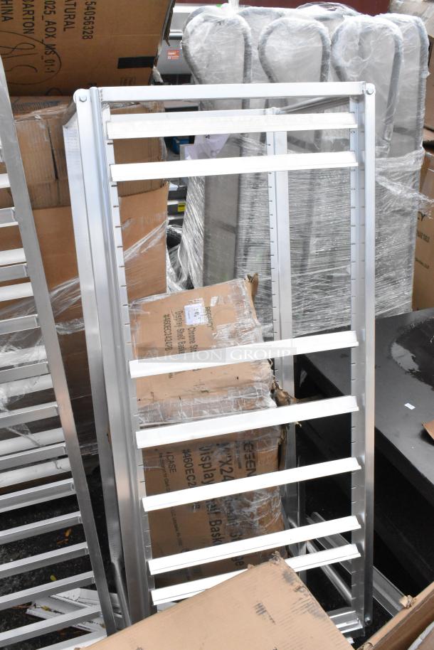 Lot of 3 metal pan racks, brand new with minor scratches and dents. Includes labels and packaging. Ideal for kitchen use.