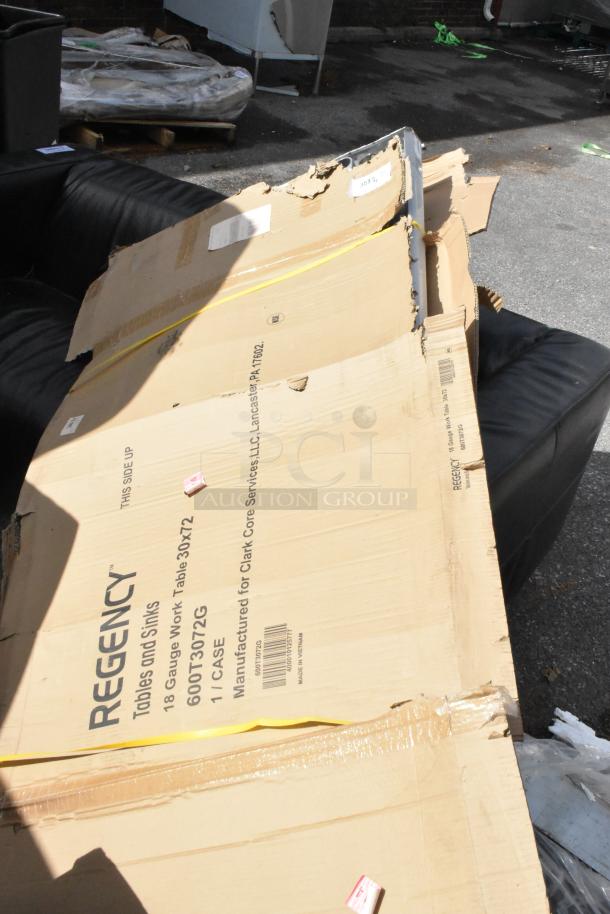 Cardboard packaging for a Regency 600T3072G 30" x 72" stainless steel work table, slightly damaged.