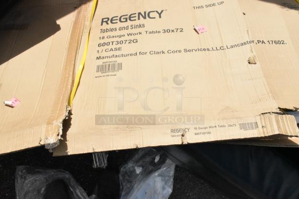 Cardboard box for Regency 600T3072G stainless steel work table, showing scratches. Labeled with specs and manufacturing info.