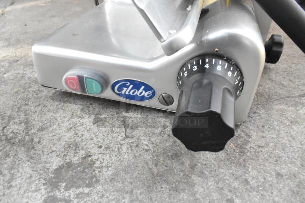 Globe G10 metal commercial countertop meat slicer with blade sharpener, 115 volts, 1 phase, dial controls, Globe logo.