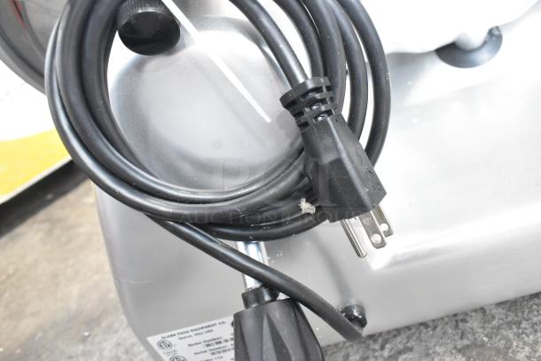 Globe G10 metal meat slicer with blade sharpener, 115V, 1 phase. Features power cord and visible manufacturer label.