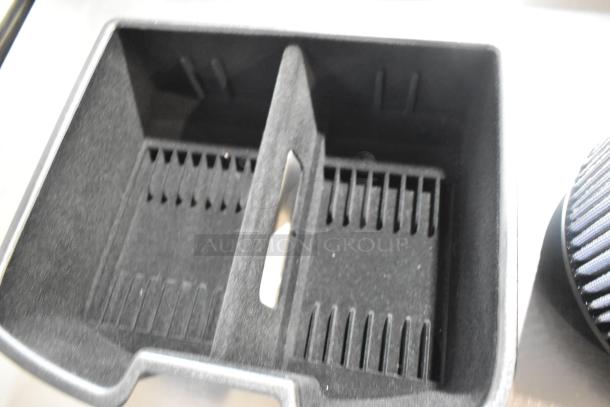 Two items including a black compartmentalized tray and a cylindrical filter, suitable for various applications.