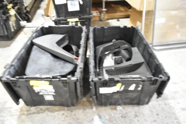 Box of parts in two black poly bins, containing various black plastic components. Labels and tags on bins.