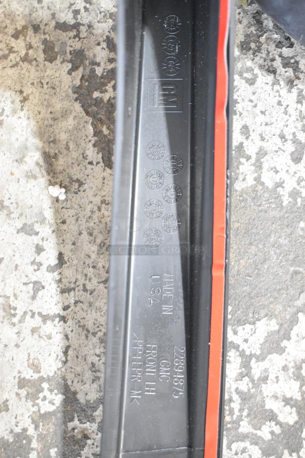 Black poly bin marked "GM", "Made in USA", model "22894875", "Front LH". Image shows detail and markings.