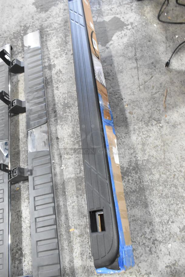 Four car parts, including side steps and running boards, in good condition. Mixed metal and plastic materials.