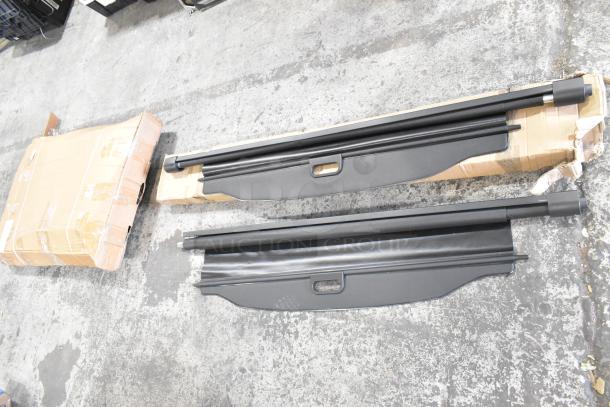 Three items: two black pull-down screens with handles and a large cardboard box. Items appear slightly used, no visible brand.