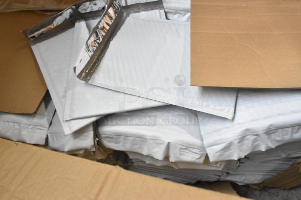 Brand new box of white bubble mailers, unopened. Ideal for secure shipping. Standard size, durable, protective packaging.