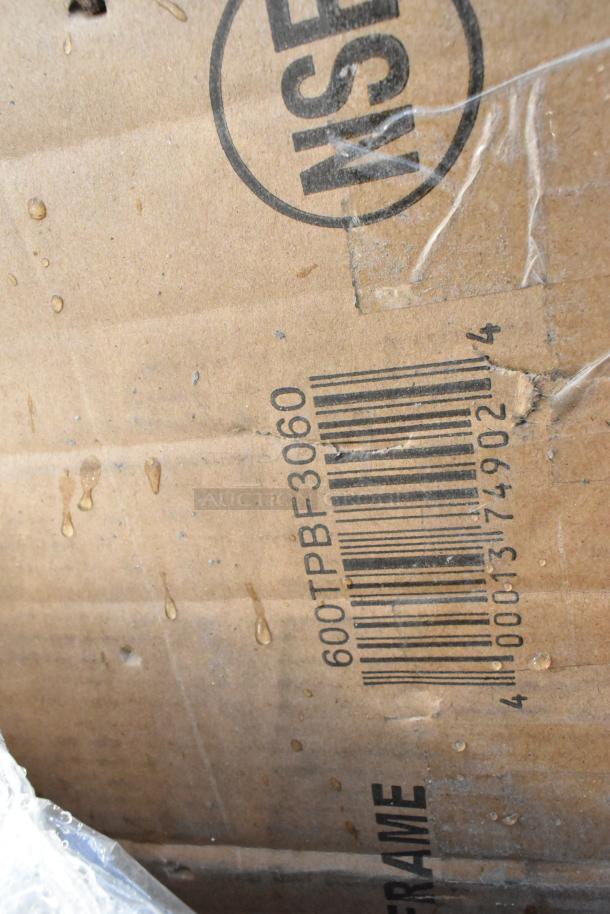 Cardboard box with "NSF" marking and barcode, indicating model 600TPBF3060. Box shows signs of wear, sealed with plastic wrap.