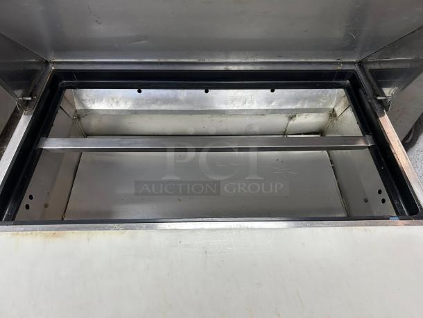 True TSSU-27-08 refrigerated prep table, open view. Solid 1 door, great condition, tested and working.
