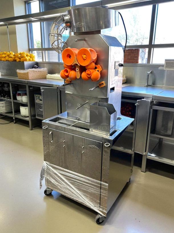 Citrocasa 8000 SB-ATS citrus juicer in excellent condition, stainless steel, with protective wrapping at base, in a kitchen setting.