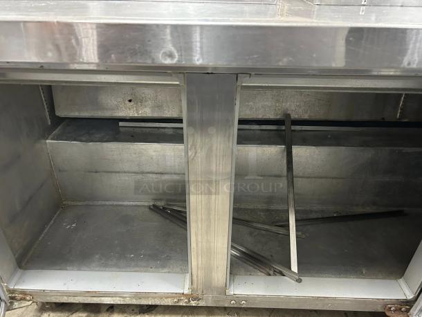 Continental SW72-N-30M 72" 3-door refrigerated sandwich prep table, stainless steel, excellent condition, interior view.