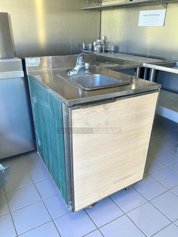 Duke Subway SUB-PS-24-CM 24" stainless steel hand sink cabinet, tested and working. Features faucet, wood panel, excellent condition.