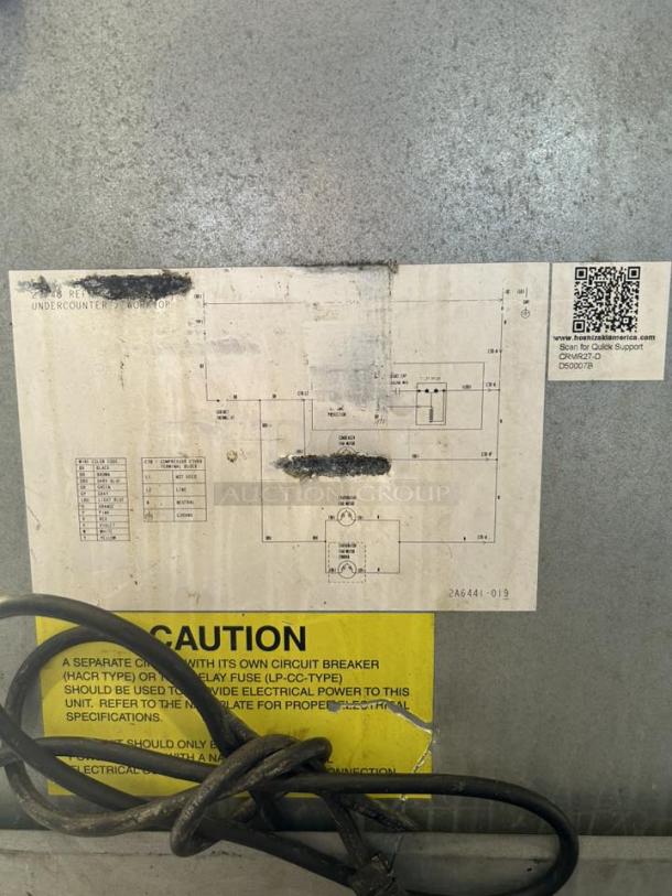 Sticker close-up on Hoshizaki UR27B-D2 refrigerator showing electrical schematic and caution label with QR code.