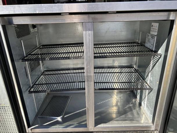 True TBB-24-48G-HC-LD 2-section glass-door cooler in excellent condition, tested and working, 49" width, metal shelves.